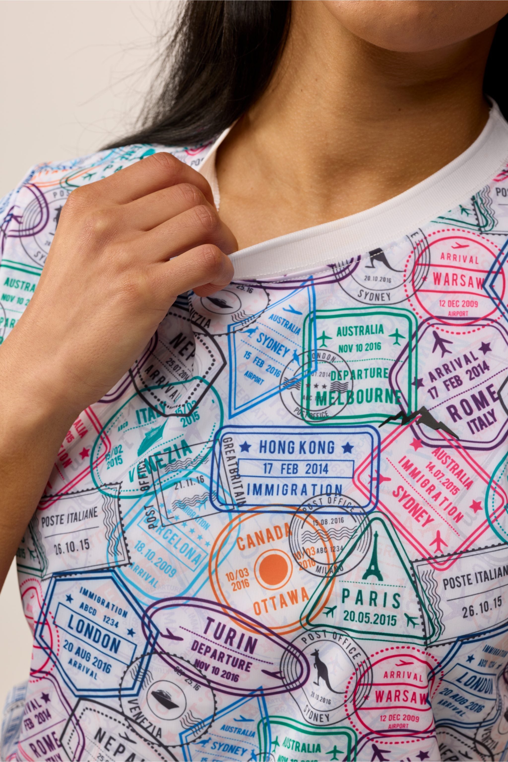Close-up of Travel Stamp shirt fabric showing detailed passport stamp print and smooth, buttery soft texture.