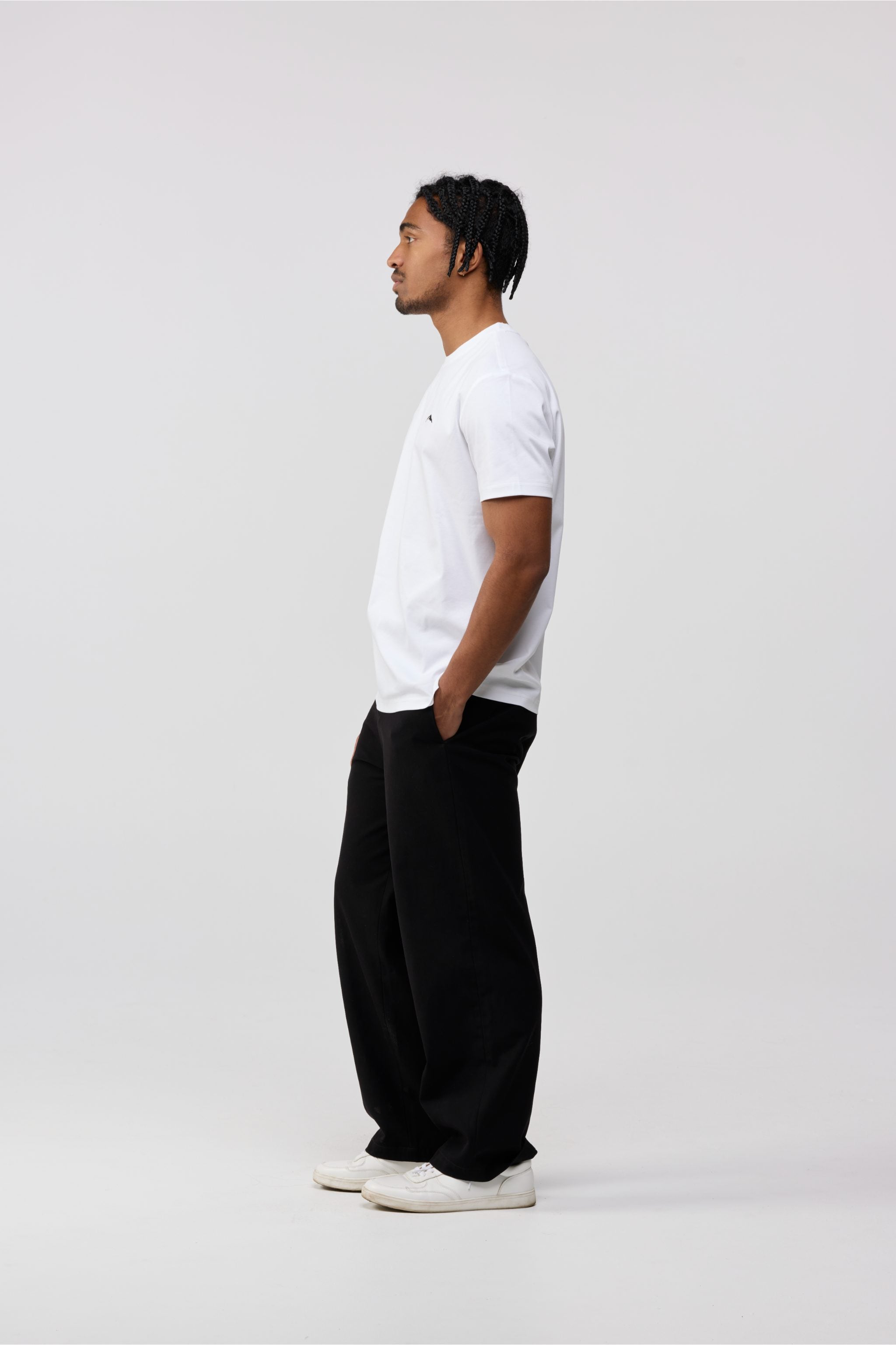Side profile of men’s white cotton crewneck short sleeve t-shirt.