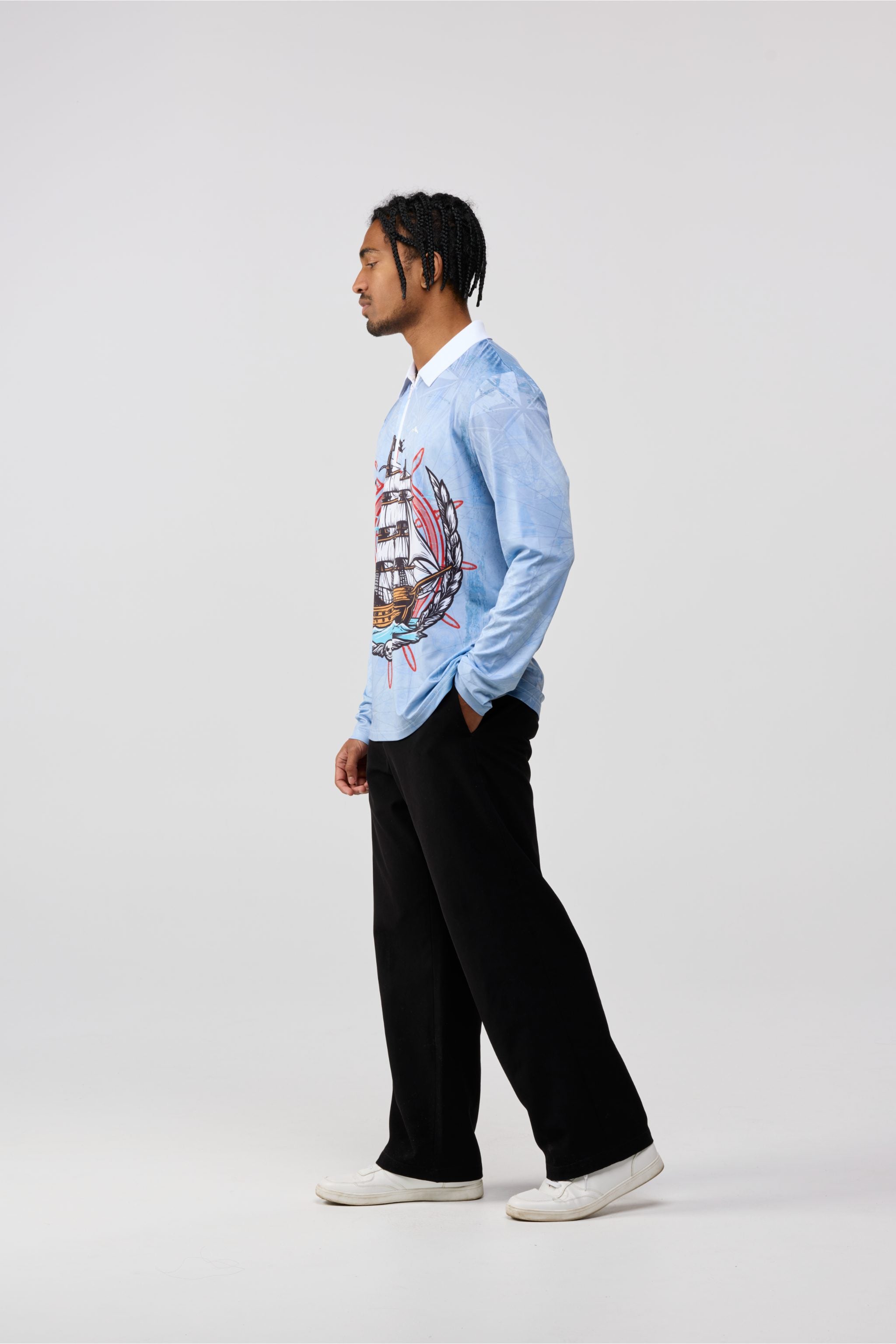 Person wearing a light blue sweater with a graphic design on a white background