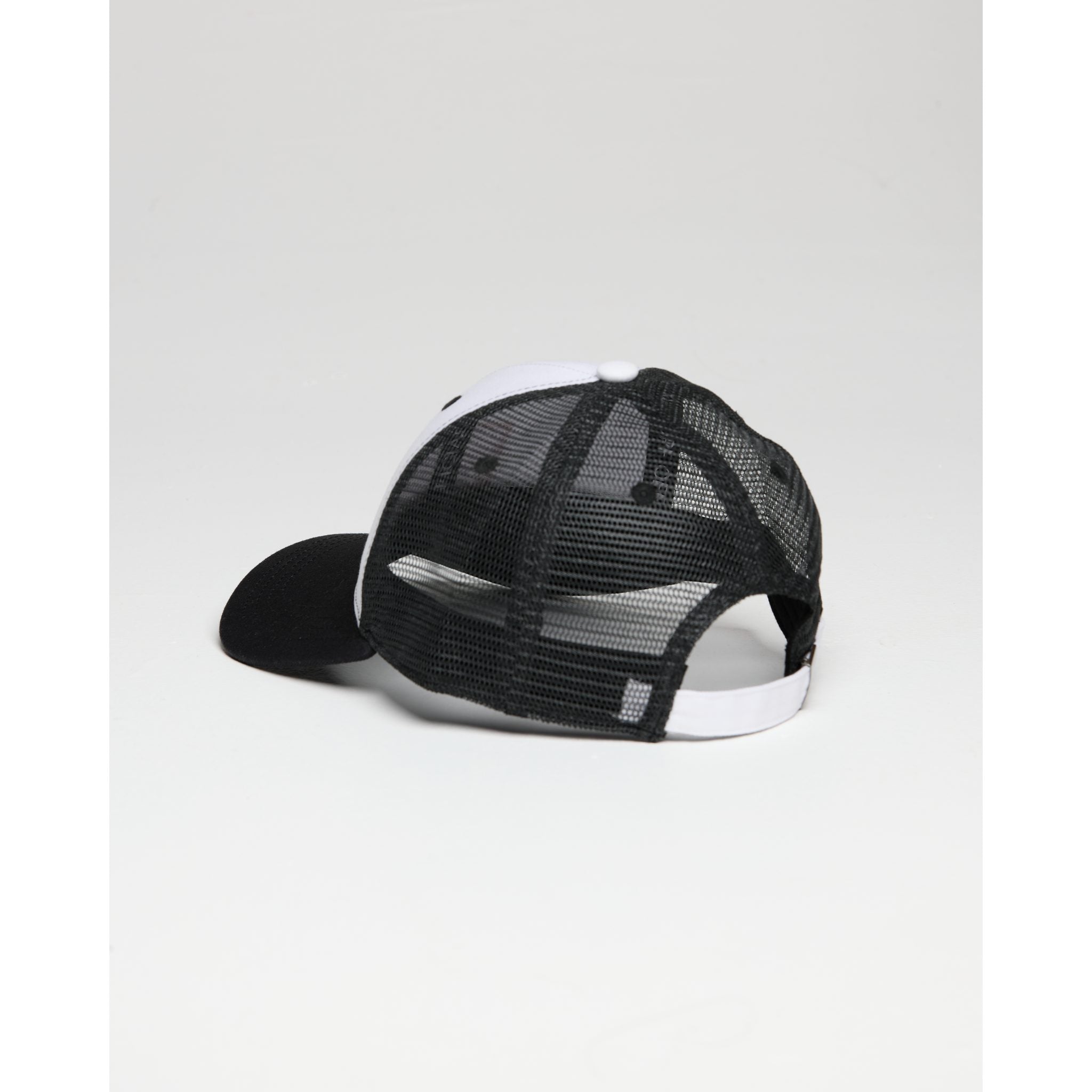Black and white cap with mesh back on a light gray background