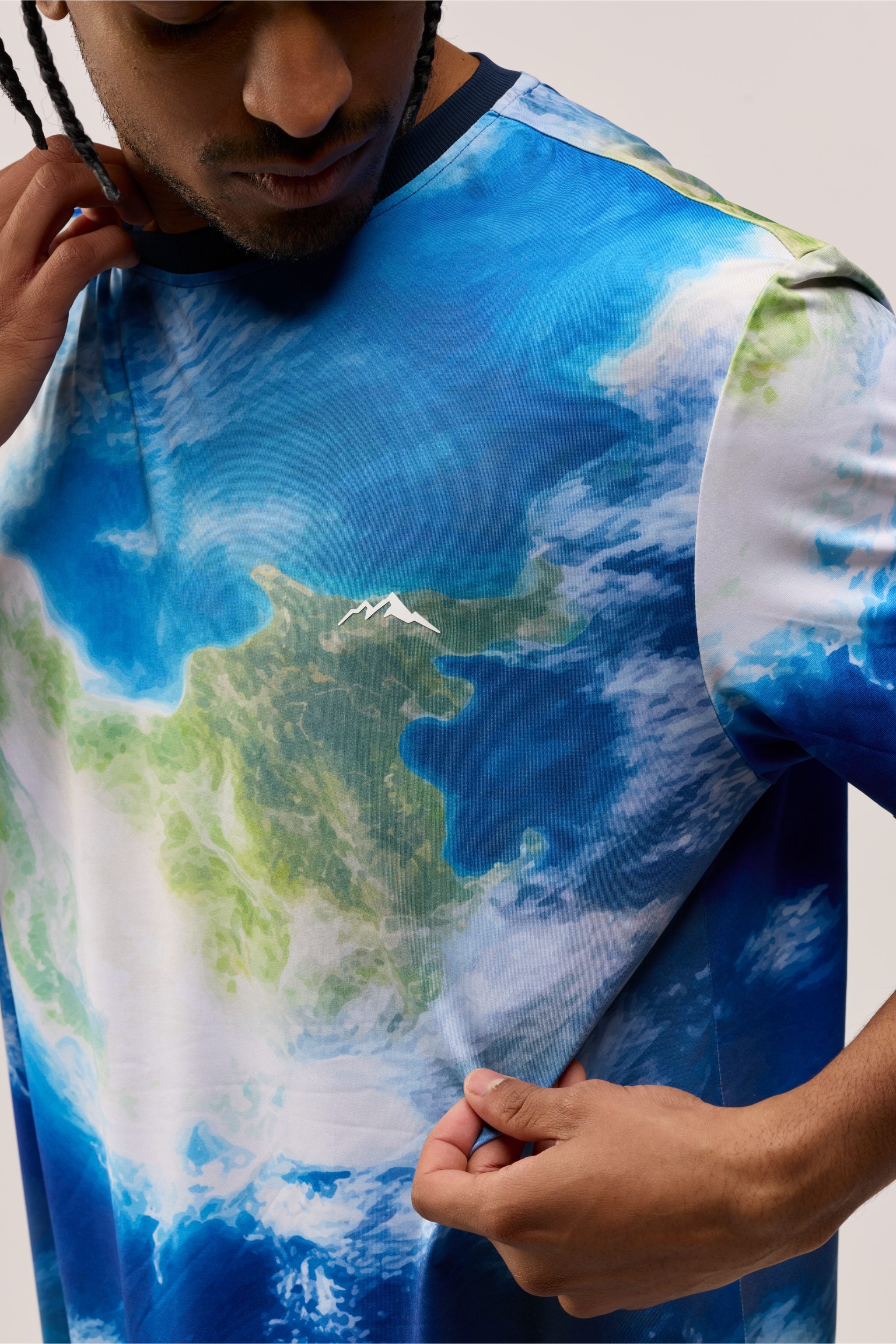Angled back-side view of Earth View shirt displaying seamless Earth artwork and stitching.
