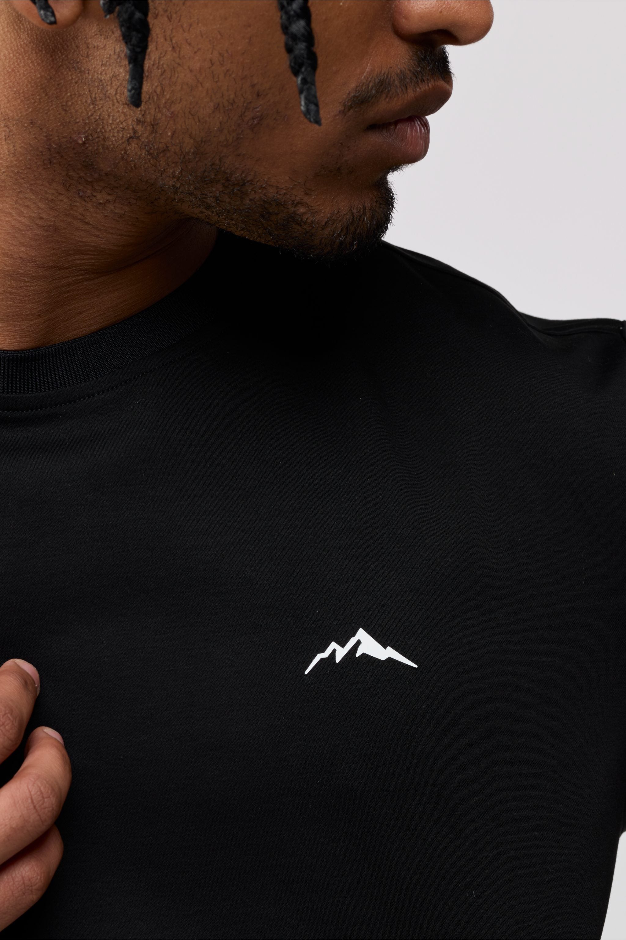 Close-up of front chest area showing fine stitching and soft cotton fabric texture.
